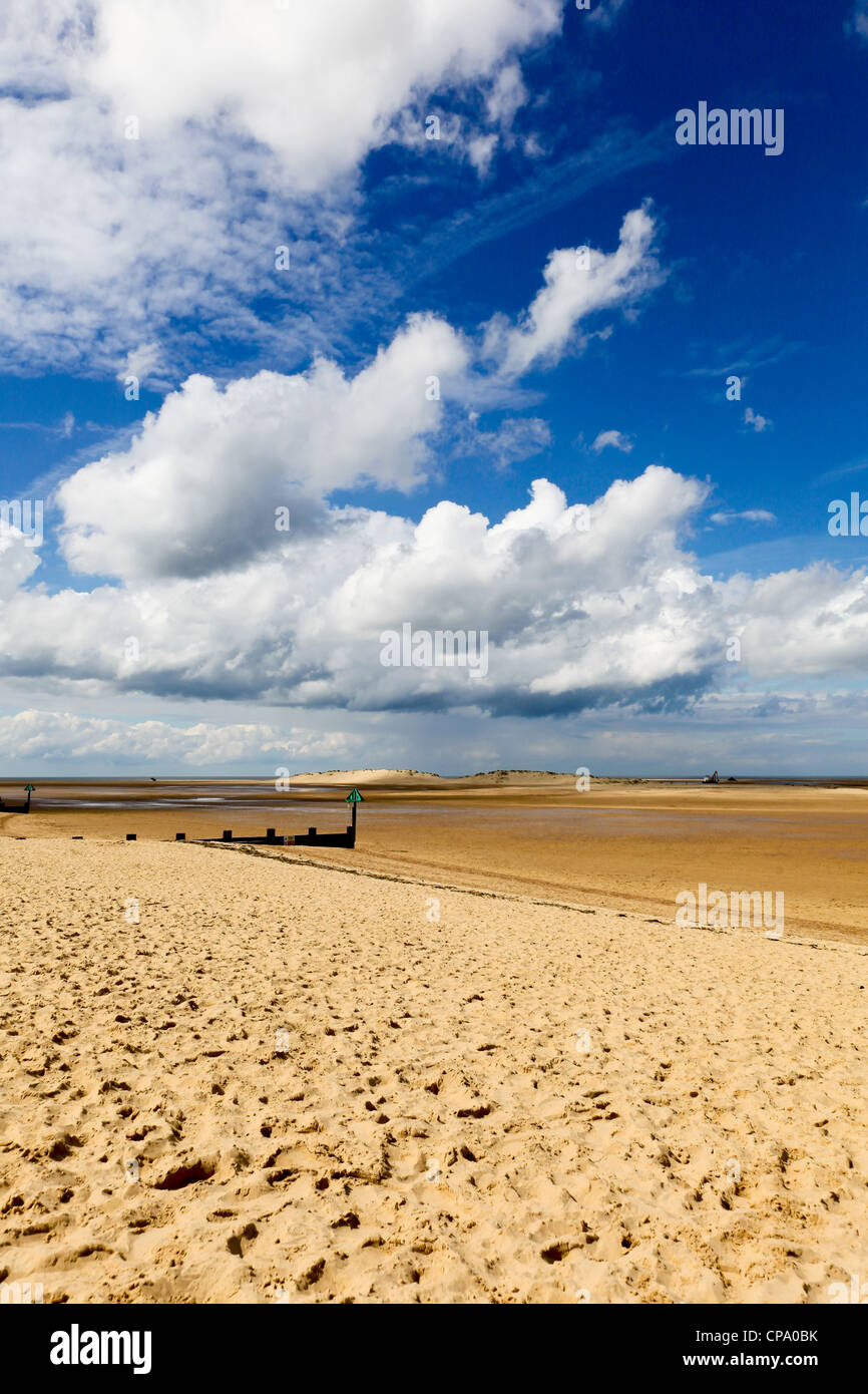 A sandy beach with a a blue sky and cloud formations overhead Stock ...