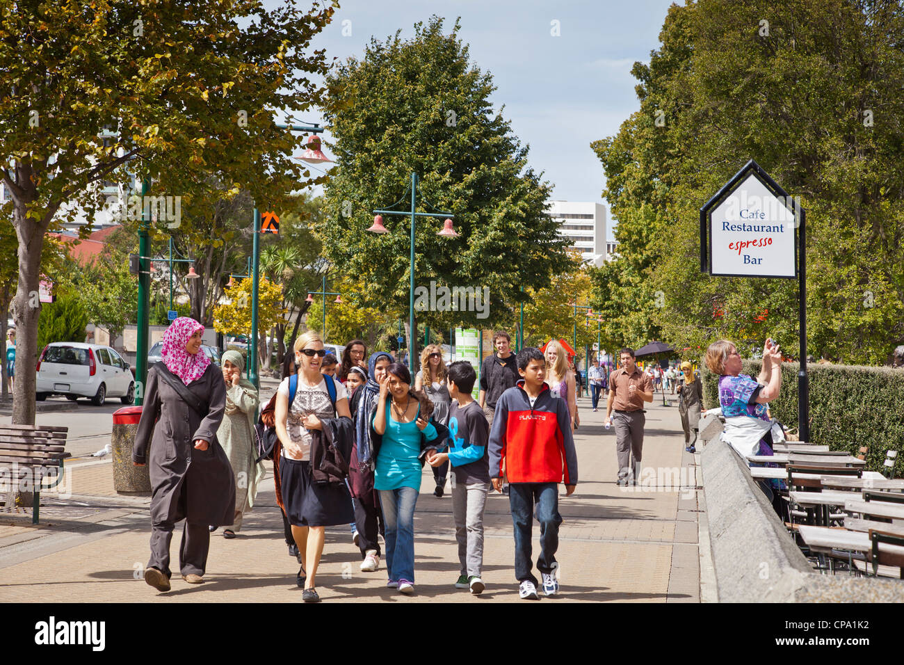 A happy group of mixed race tourists walking in Worcester Boulevard. Stock Photo
