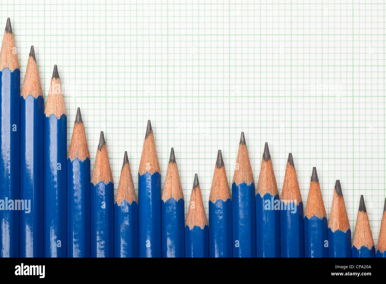 Pencils forming a downtrend chart on graph paper Stock Photo