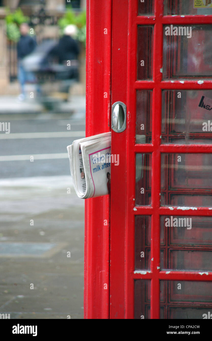 Newspaper in British phonebox in London Stock Photo