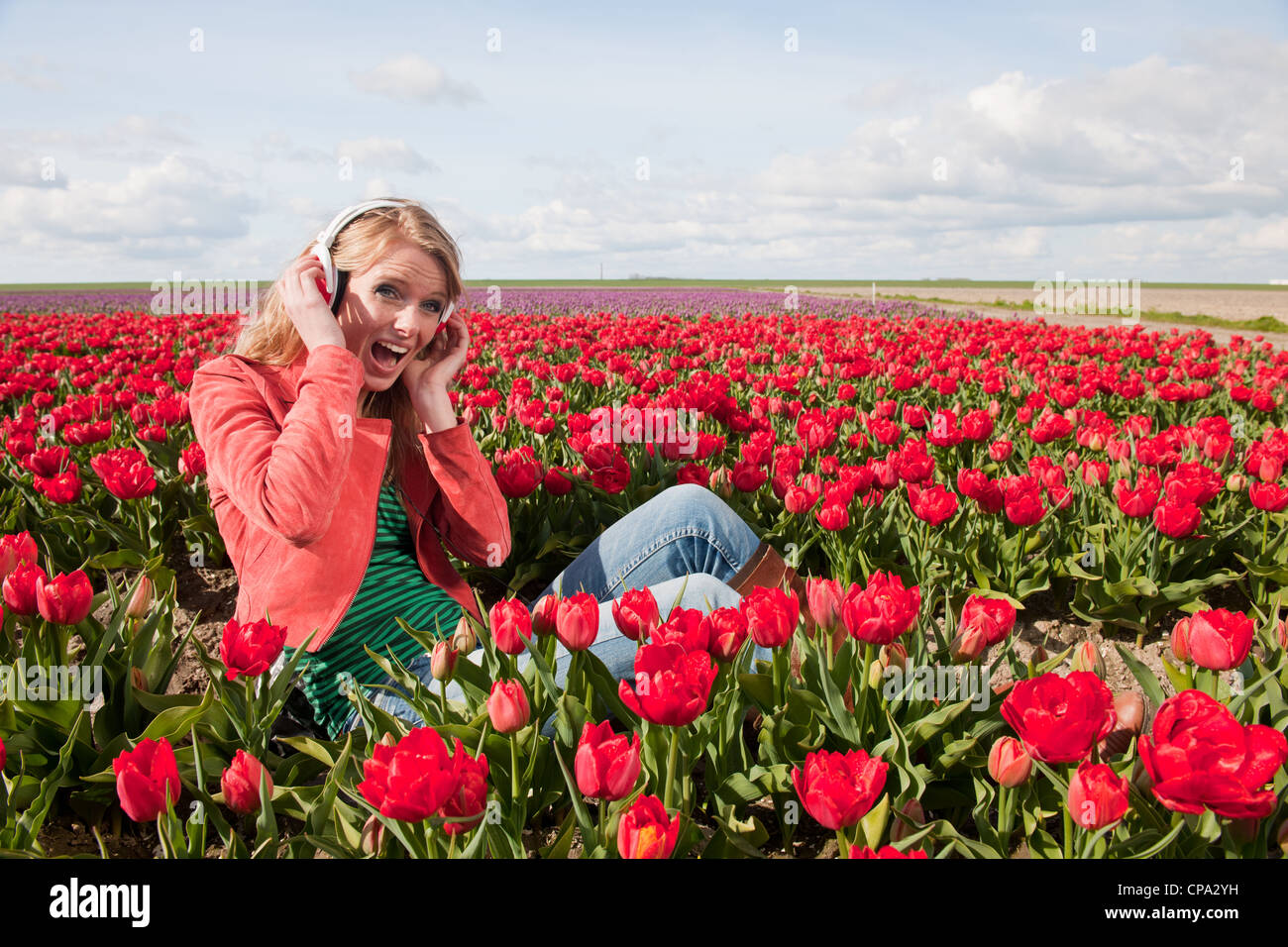 Dutch girl with long blond hair is listening to music Stock Photo - Alamy