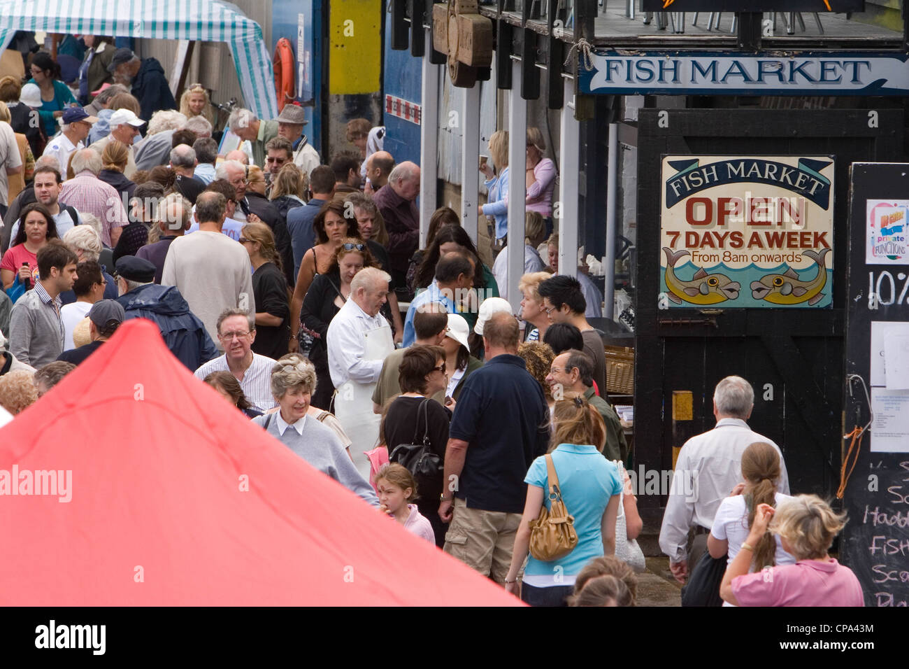 Market stalls and visitors, Whistable Harbour, Kent, England, UK Stock Photo