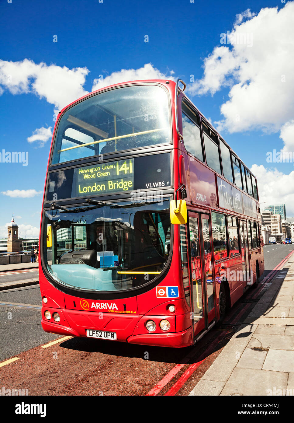 Red London bus on London Bridge, England. Stock Photo