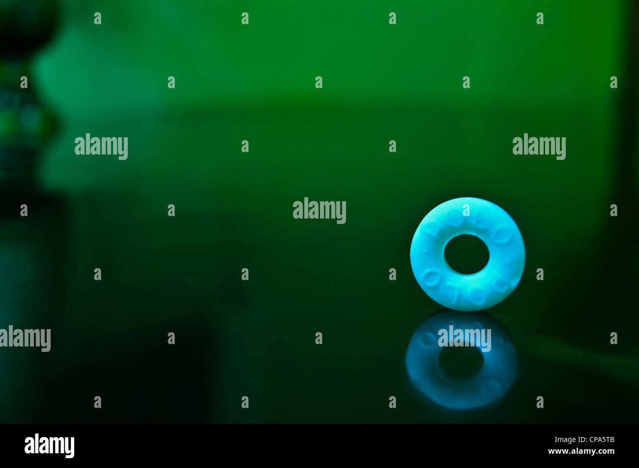 Polo "The Mint with a Hole" chocolate candy against green background