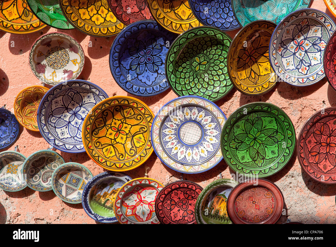 Selection of colourful Moroccan plates on a wall in Marrakech Stock