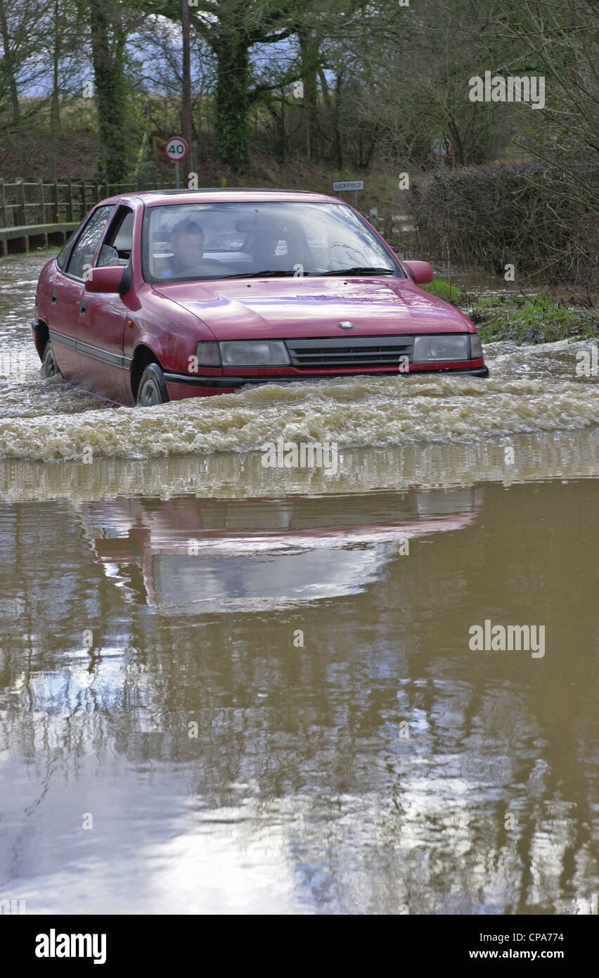 Vehicles passing through floods in Sussex Stock Photo