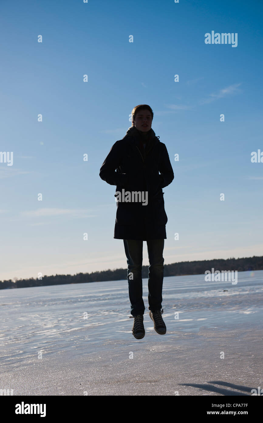 Young man sliding around on a frozen lake Stock Photo - Alamy