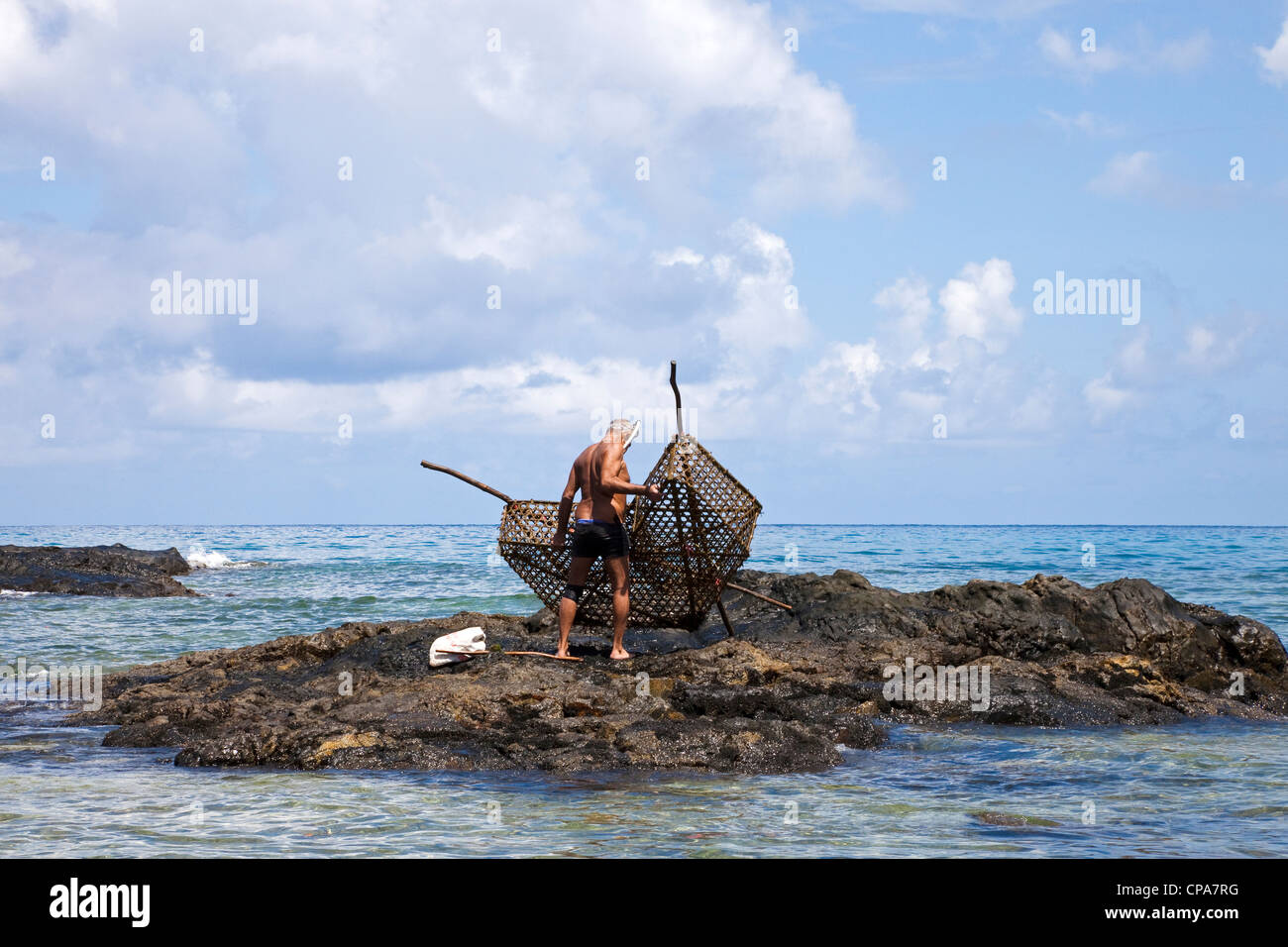 Local fisherman using traditional methods of fishing with a wicker