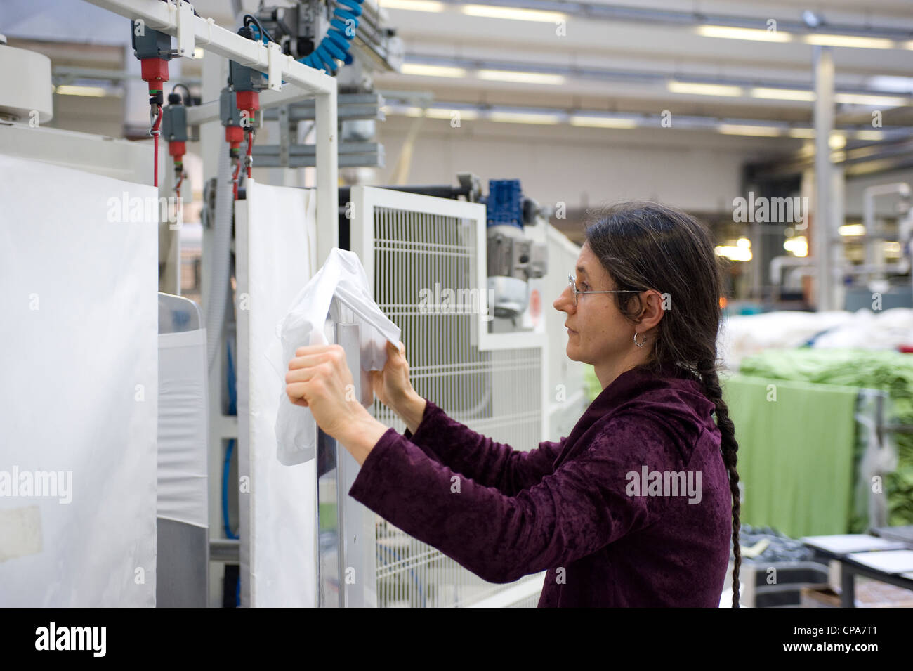 A female worker at the ironing machine, Burladingen, Germany Stock Photo