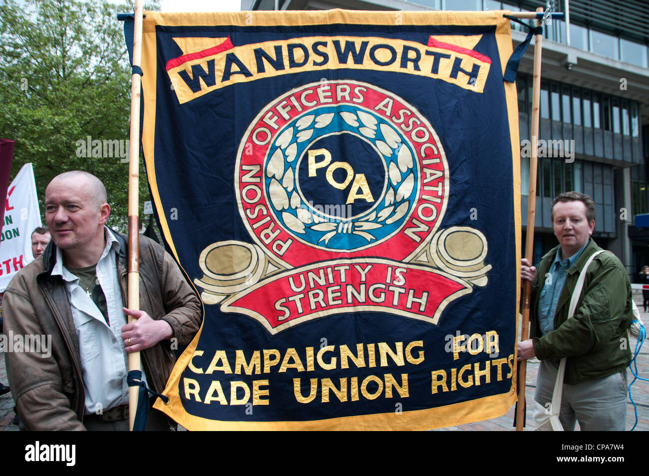 Public sector workers demonstrate against changes to their pension. Prison officers from Wandsworth carry their Union banner Stock Photo