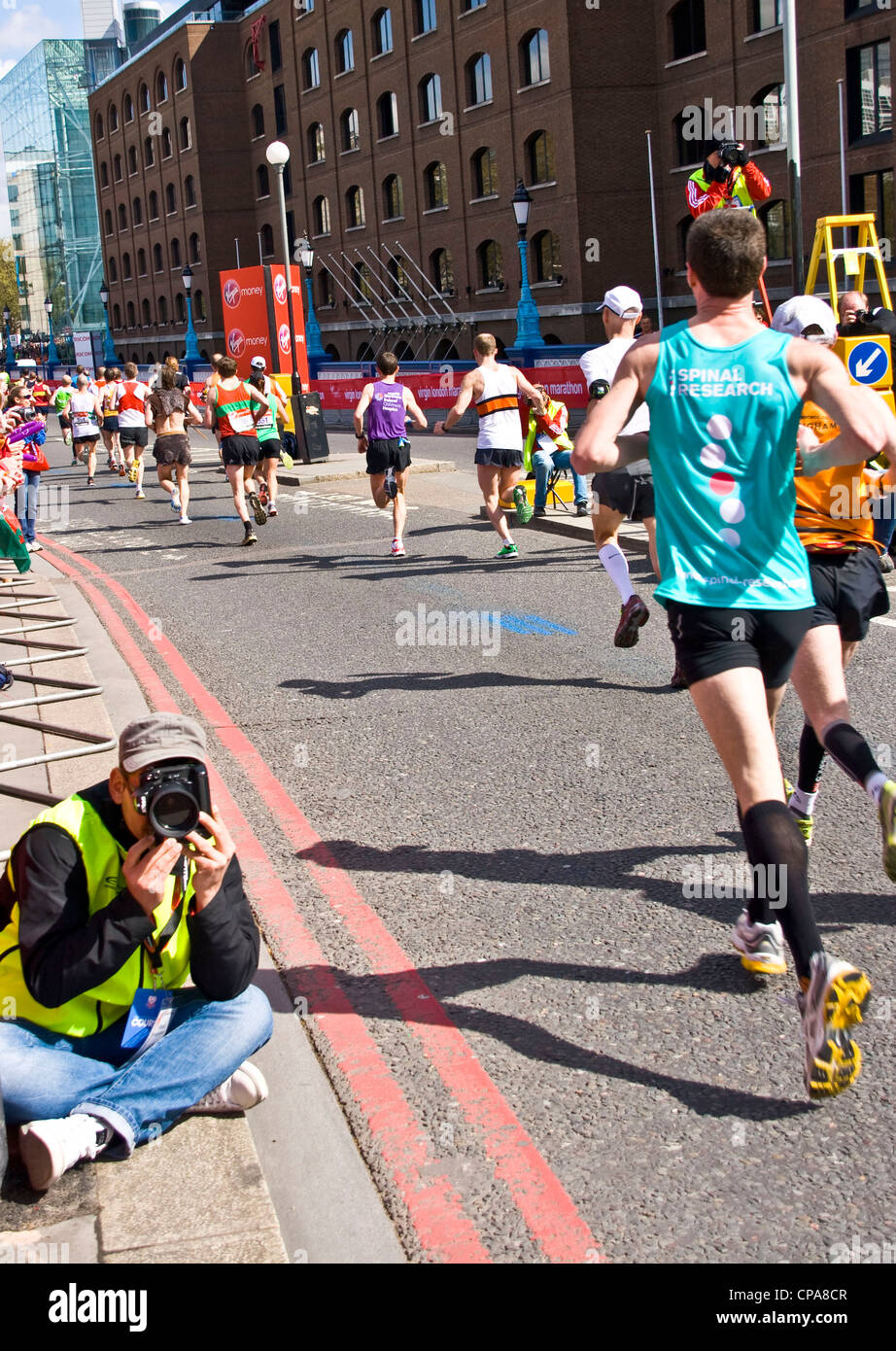 2012 London marathon runners crossing grade 1 listed Tower Bridge London England Europe Stock Photo