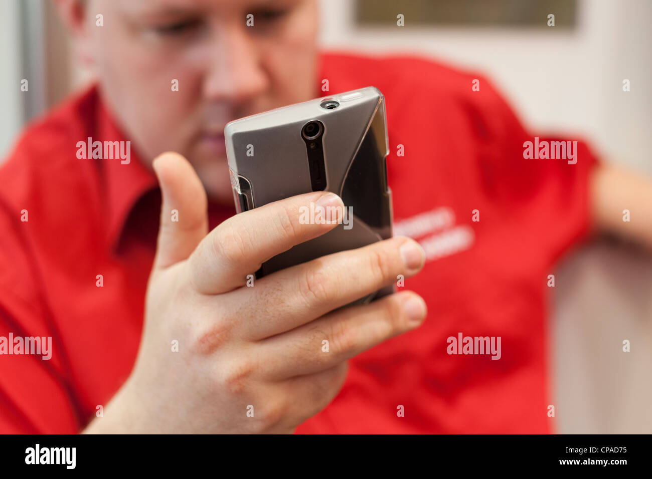 Man reading on his smart phone at work -close-up Stock Photo