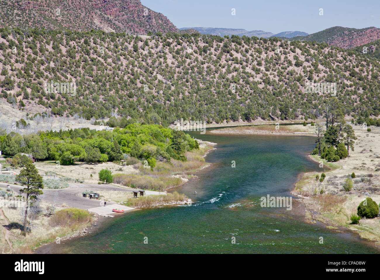 Green River at Little Hole, Utah, below Flaming Gorge Dam, boat ramp with a raft and fisherman, spring with fresh green colors Stock Photo