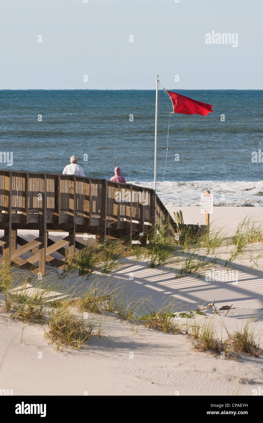 USA, Alabama, Gulf Shores. Red warning flag posted to indicate winds/tides causing dangerous swimming conditions Stock Photo