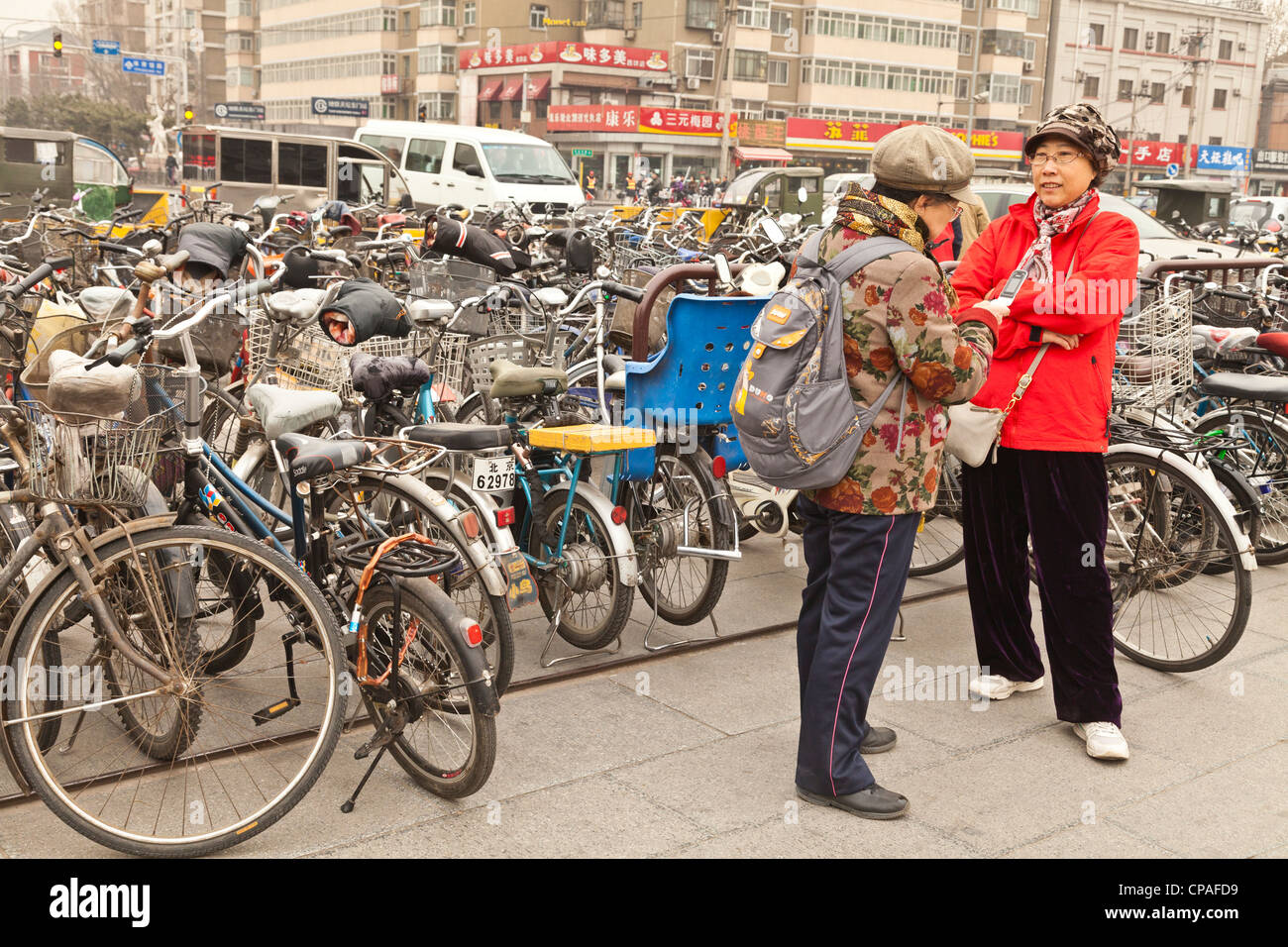 Bikes parked near the Temple of Heaven, Beijing, China, two senior Chinese women talking together. Stock Photo