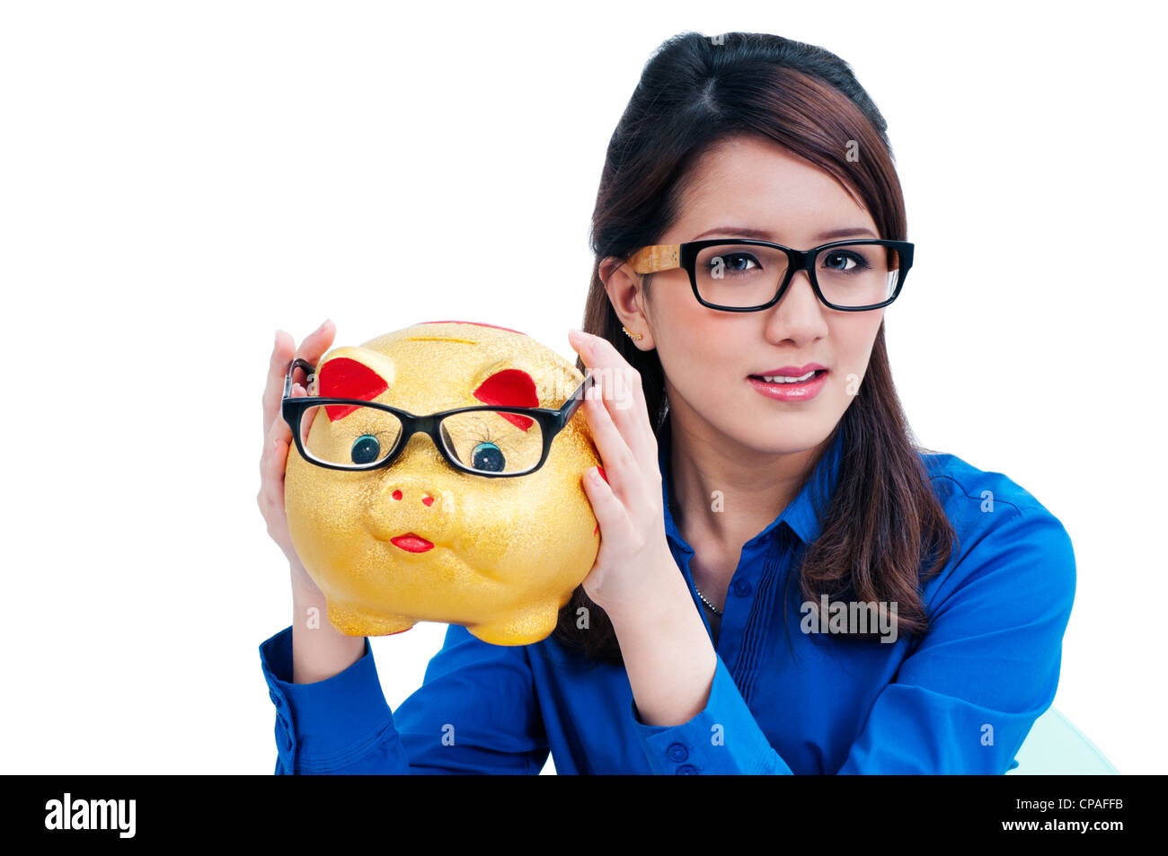 Cute young woman holding piggy bank Stock Photo - Alamy