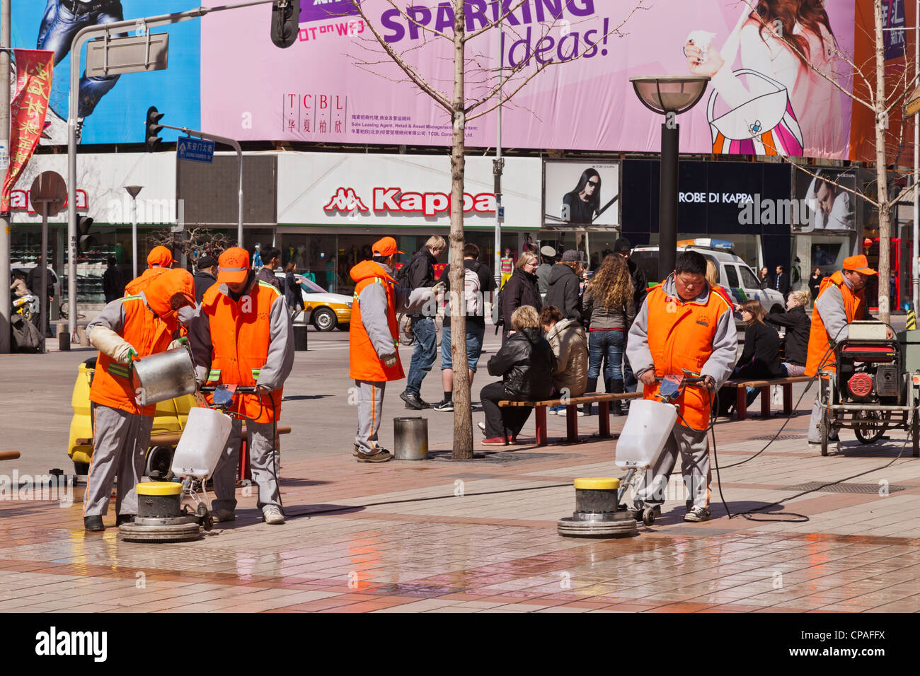 Workers using industrial cleaners to clean the paving in Wangfujing Street, Beijing, China. Stock Photo