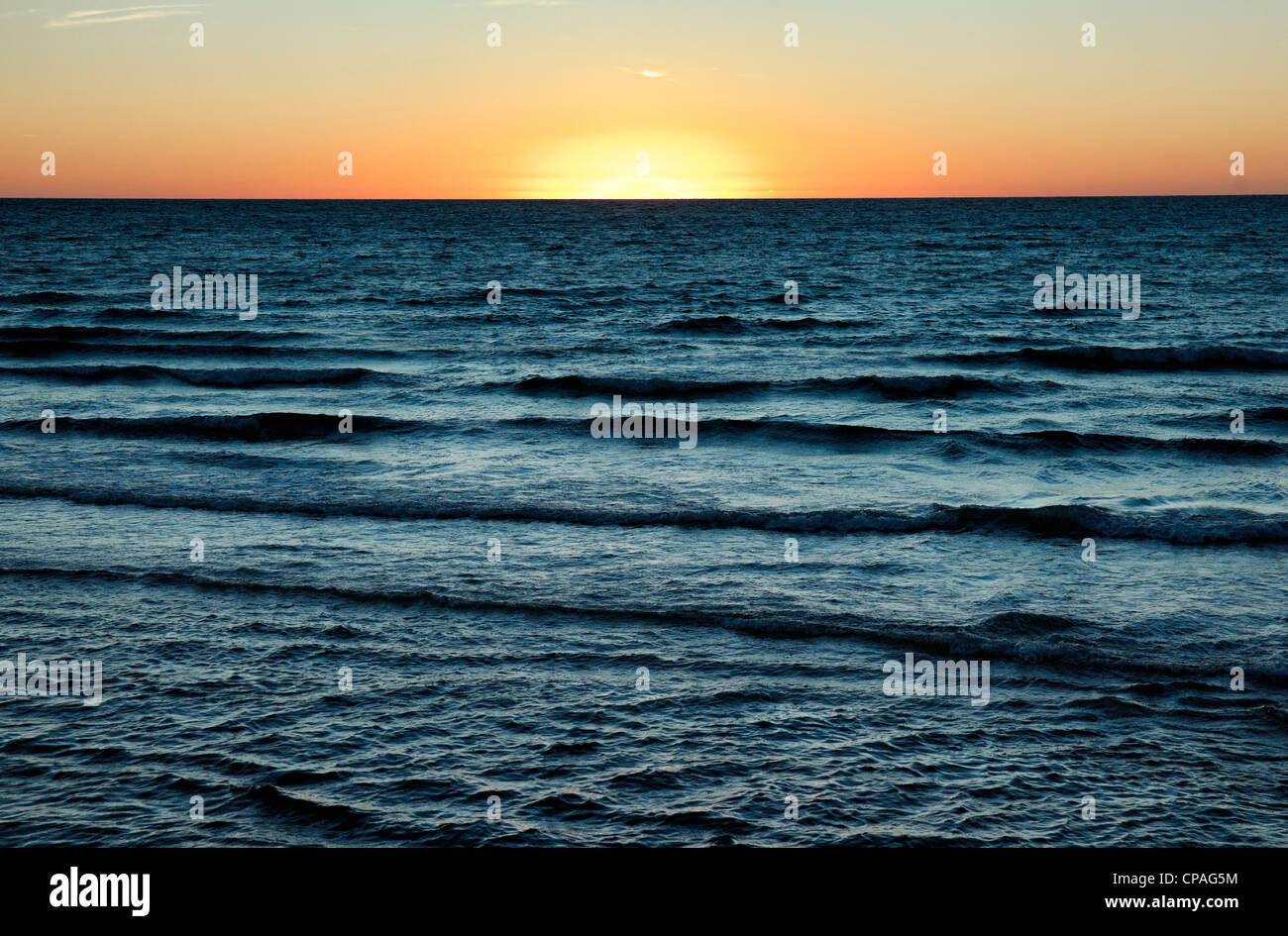 sun is setting over the sea at semaphore south australia Stock Photo