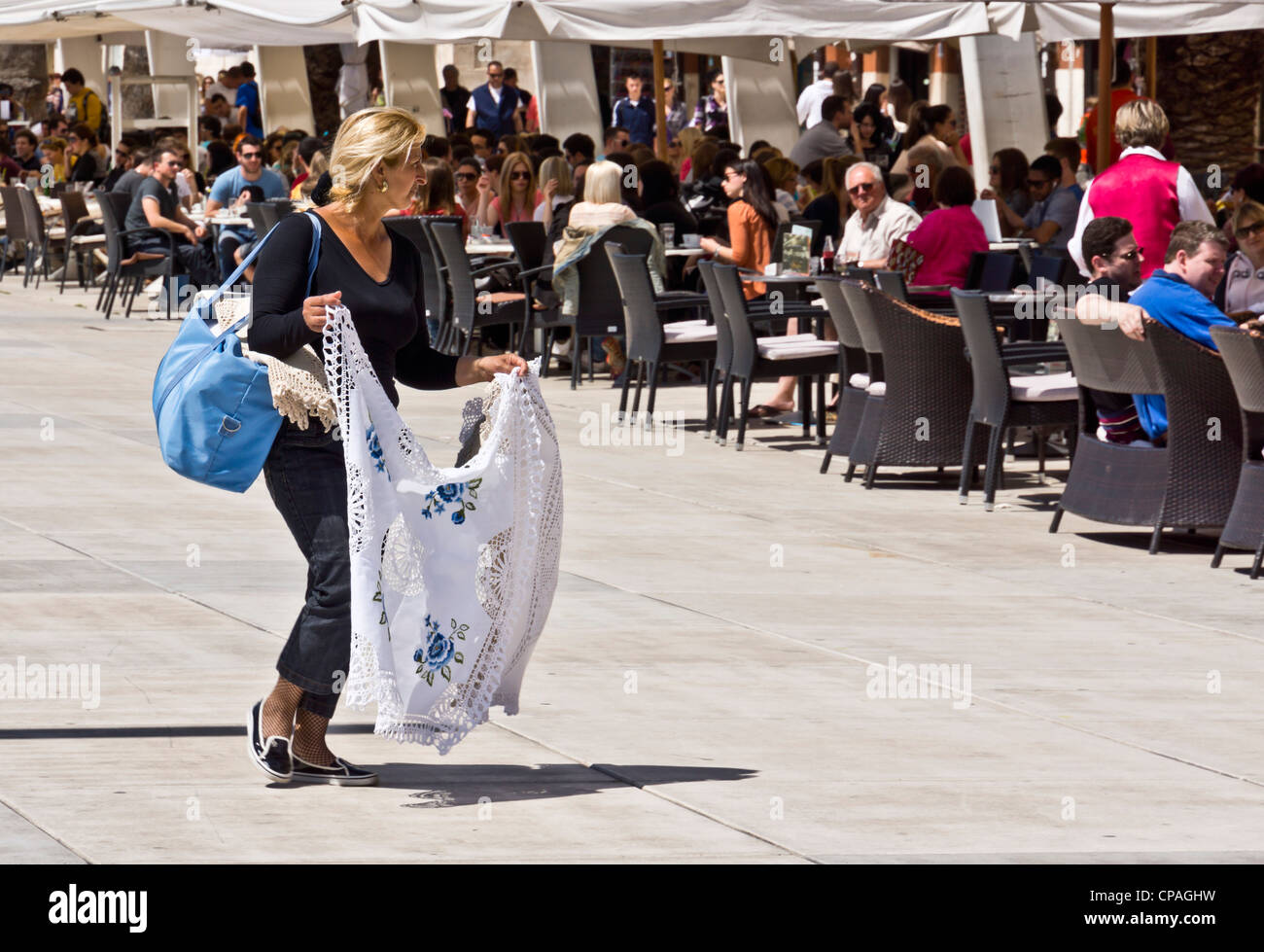 Split, Dalmatian coast of Croatia - the Riva seafront walk. Woman selling lace. Stock Photo