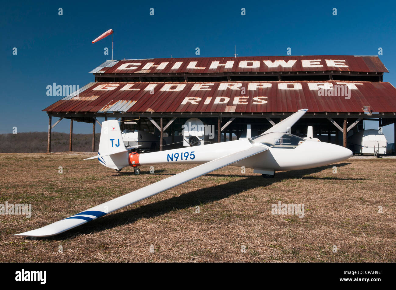 USA, TN, Chilhowee Gliderport. Fiberglass sailplane in front of barn shed. (PR) Stock Photo