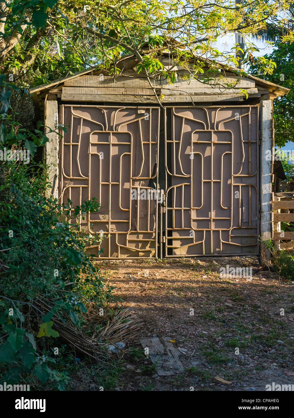 Double garage doors with tubular metal decoration on the outside resembling a labyrinth in a single car garage in Viñales, Cuba. Stock Photo