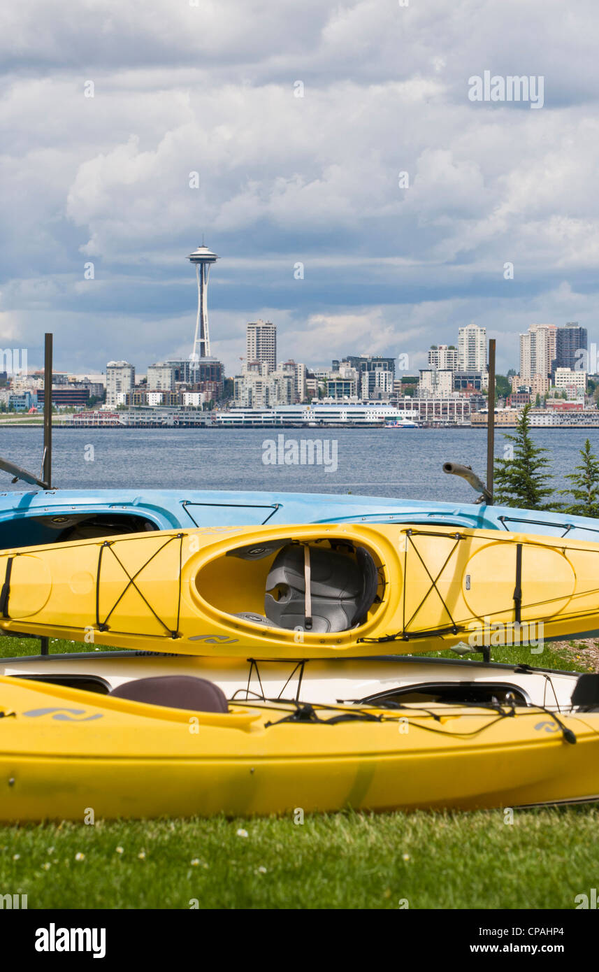 US, WA, Seattle Kayaks on racks, West Seattle frame the downtown Seattle skyline, Space Needle and waterfront across Elliott Bay Stock Photo