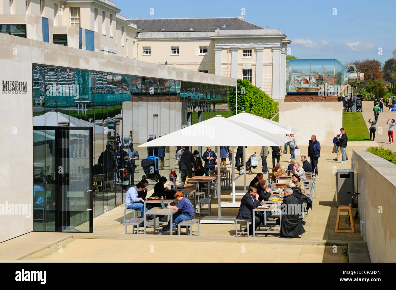 Cafe facilities on the terrace outside National Maritime Museum in Greenwich Park with Nelson's Victory ship in a bottle beyond Stock Photo