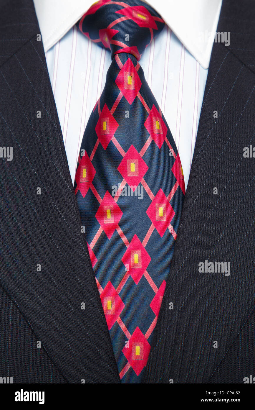 Photo of a blue pinstripe suit with blue striped shirt and red and blue patterned tie Stock Photo