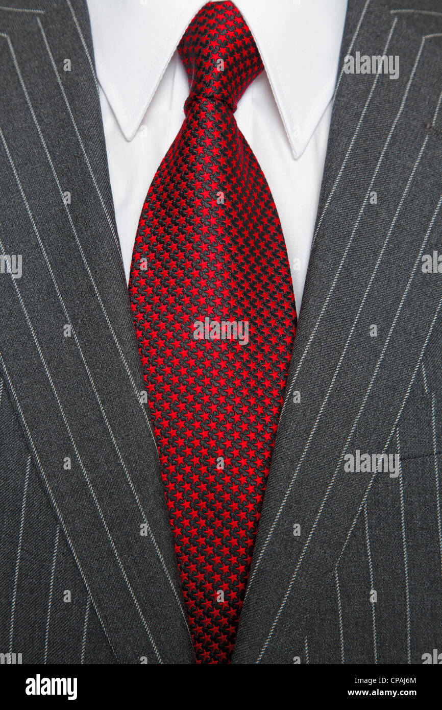 Photo of a grey pinstripe suit with plain white shirt and red patterned tie Stock Photo