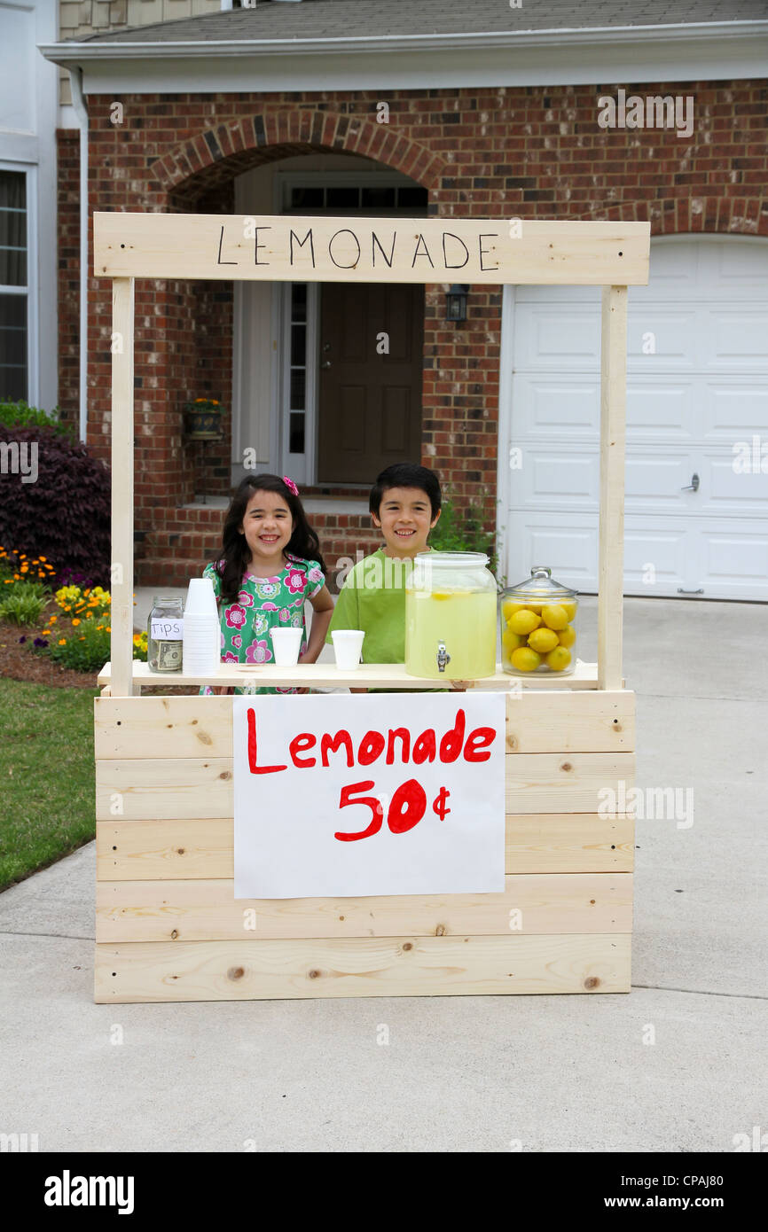 Children selling lemonade in front of their home Stock Photo Alamy