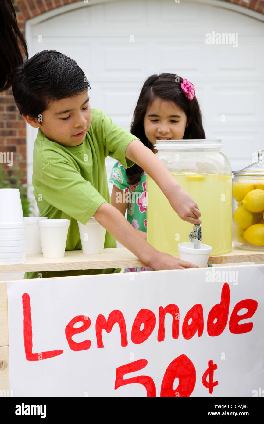 Children selling lemonade in front of their home Stock Photo Alamy