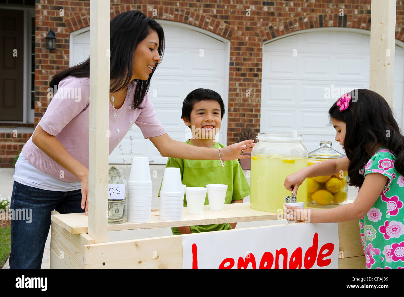 Children selling lemonade in front of their home Stock Photo Alamy