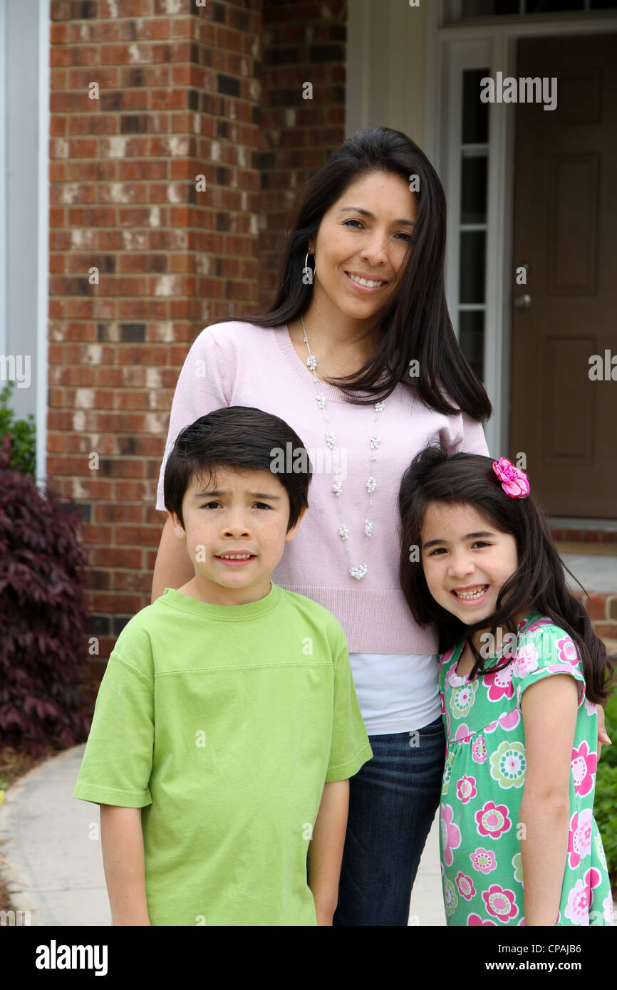 Family standing outside their home in summer Stock Photo - Alamy