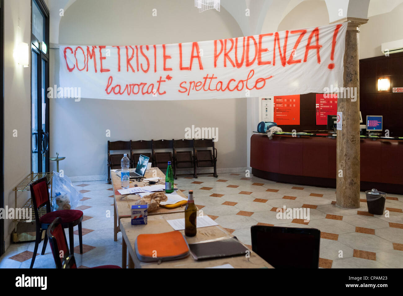 Protest banner hanging inside the Valle Theatre during a protest occupation, Rome, Italy Stock Photo