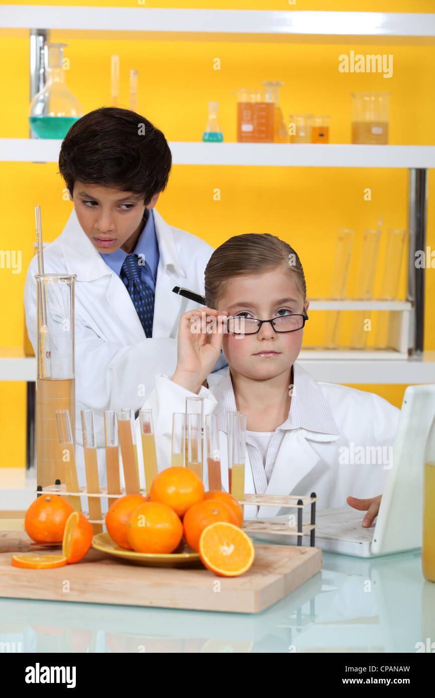 Children doing chemistry experiments with orange juice Stock Photo Alamy