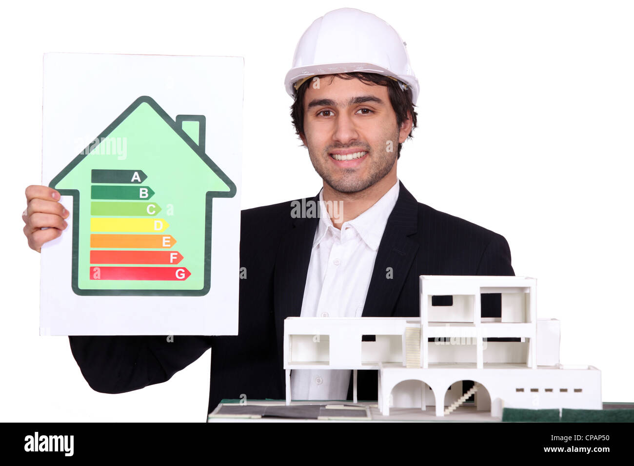 Architect holding model house and energy rating poster Stock Photo