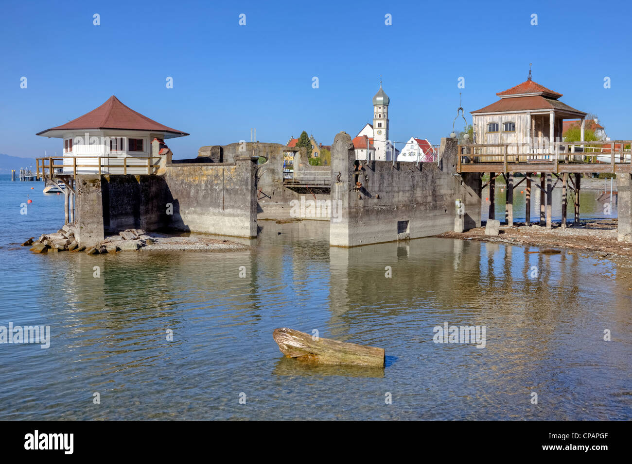 old bath houses, Lake Constance, Wasserburg, Bavaria, Germany, in the background, the Catholic parish church of St. George Stock Photo