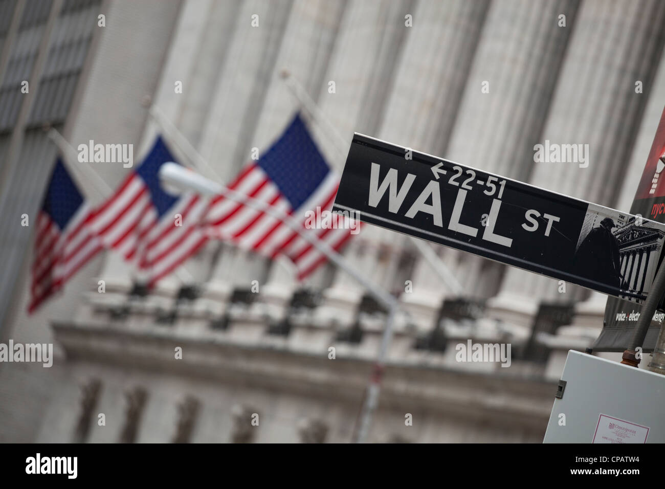 Wall Street sign in front of New York Stock Exchange in Manhattan, New York City Stock Photo