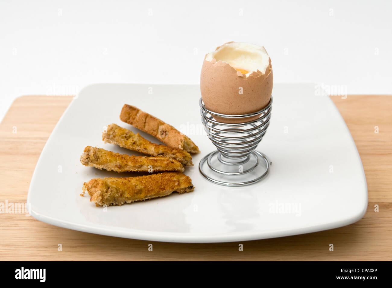 Soliders Toast Soft boiled egg and soldiers toast in metal egg cup on white background ...