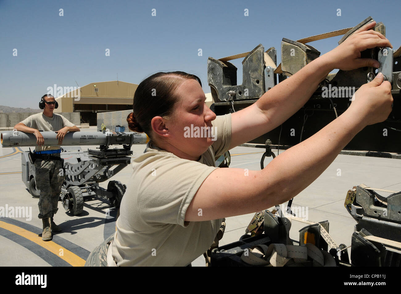 Airman 1st Class Rhiannon O’Leary, an ammo technician assigned to the 451st Expeditionary Maintenance Squadron at Kandahar Airfield, Afghanistan, prepares the ammunition rack for missiles that were downloaded from an F-16 Fighting Falcon May 3, 2012. A1C O’Leary is deployed from McEntire Joint National Guard Base, S.C., in support of Operation Enduring Freedom. Swamp Fox F-16’s, pilots, and support personnel began their Air Expeditionary Force deployment early April to take over flying missions for the air tasking order and provide close air support for troops on the ground in Afghanistan. Stock Photo