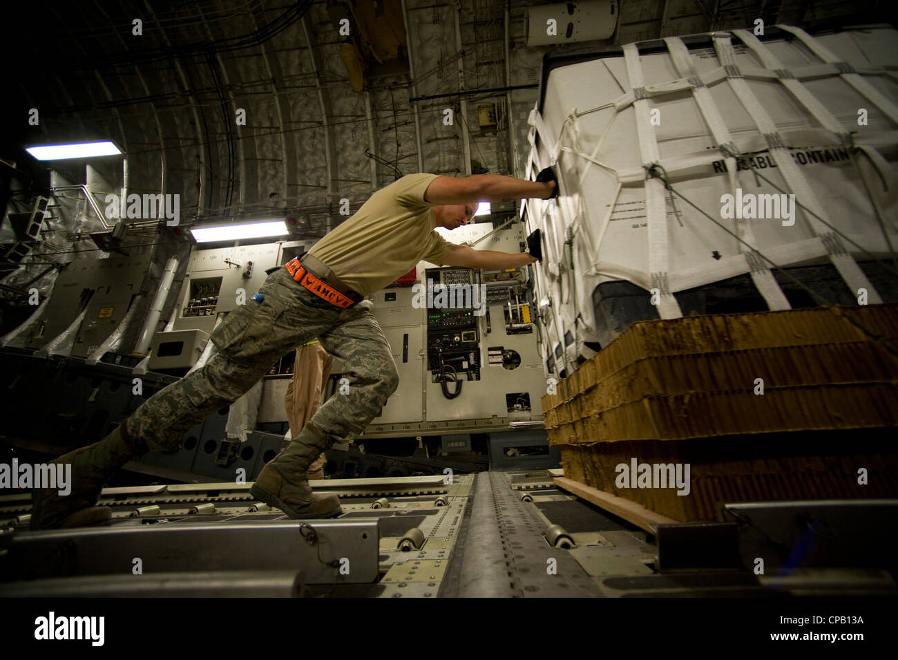 A Member Of The 8th Expeditionary Air Mobility Squadron Pushes A