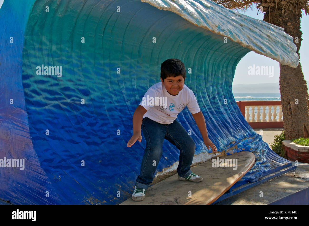 Boy on surfboard on sculptured wave Pichilemu Chile Stock Photo