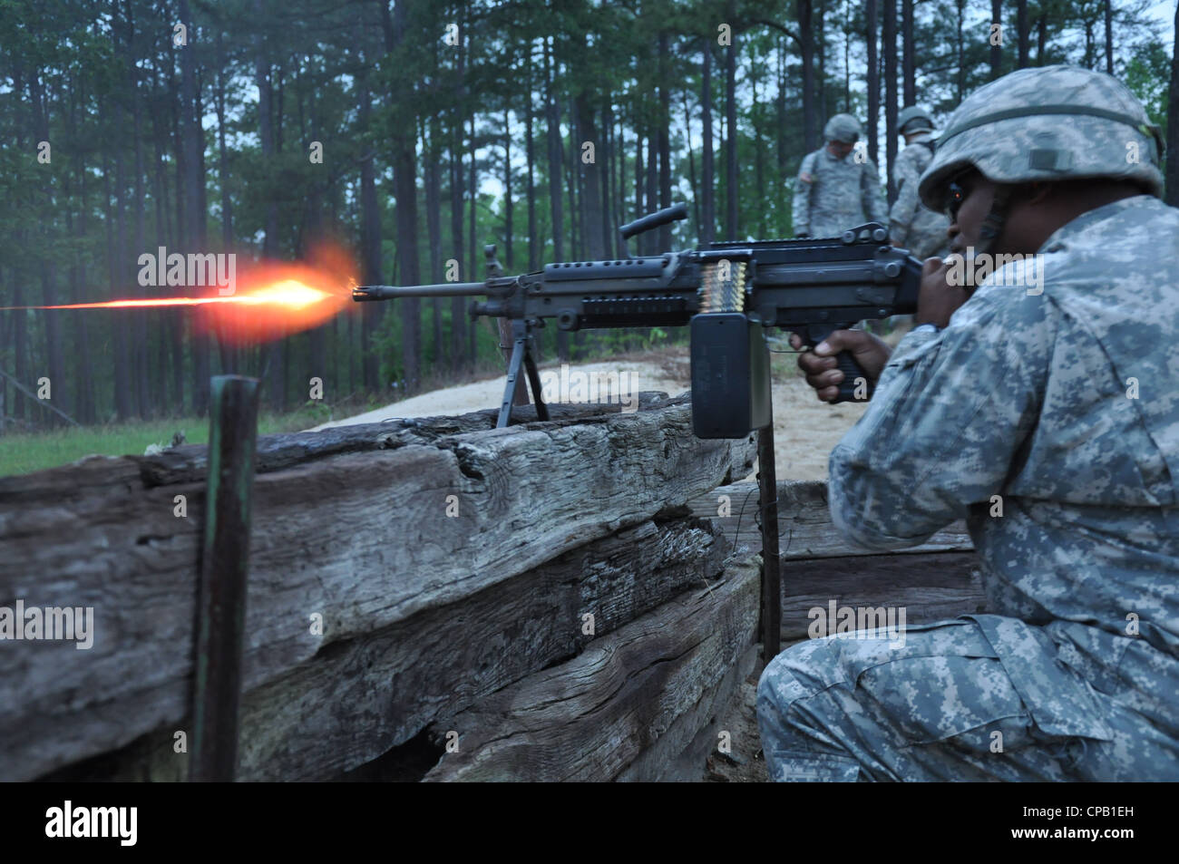 Sgt. Carl Hawthorne of the 273rd Military Police Company (Rear Detachment), District of Columbia National Guard, fires tracer rounds from an M249 machine gun during crew-served weapon night fire training at Fort A.P. Hill, Va., May 5, 2012. Stock Photo