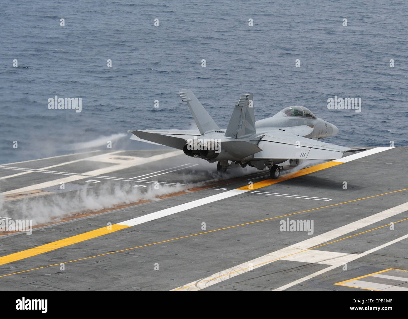 An F/A-18F Super Hornet assigned to the Black Knights of Strike Fighter Squadron (VFA) 154 launches from the aircraft carrier USS Nimitz (CVN 68). Nimitz is conducting carrier qualifications off the coast of southern California. Stock Photo