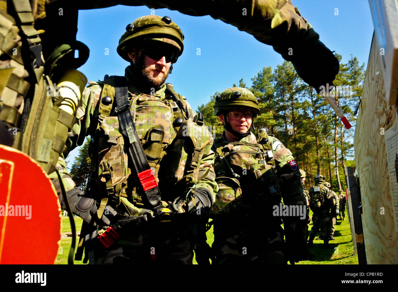 Slovakian soldiers discuss grouping techniques after firing at the range during an Operational Mentor Liaison Team (OMLT) training exercise at the Joint Multinational Readiness Center in Hohenfels, Germany, May 8, 2012. OMLT XXIII and Police Operational Mentor Liaison Team (POMLT) VII training are designed to prepare teams for deployment to Afghanistan with the ability to train, advise, and enable the Afghan National Security Force in areas such as counter-insurgency, combat advisory, and force enabling support operations. Stock Photo