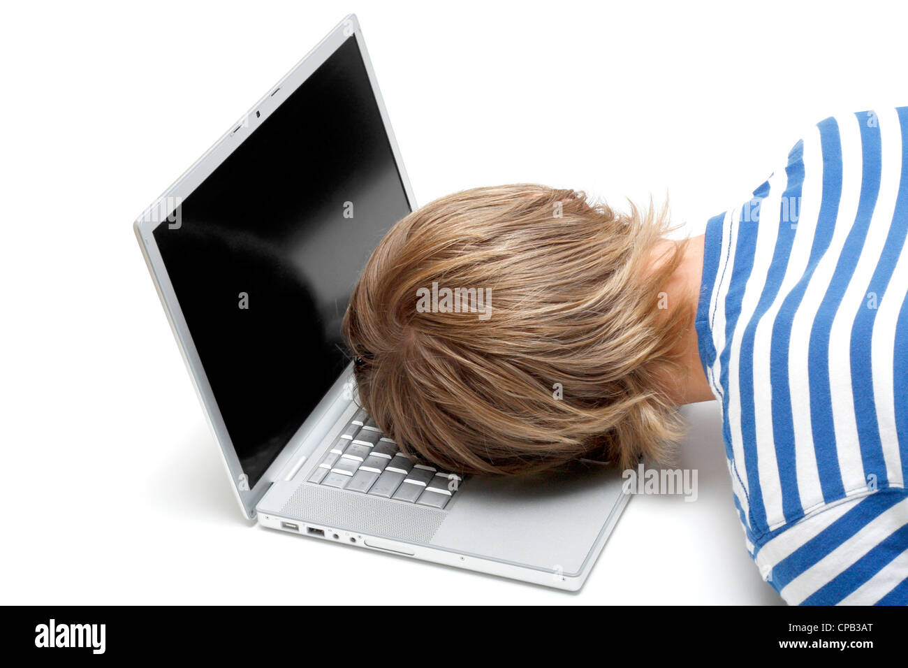 A man sleeping on his laptop Stock Photo