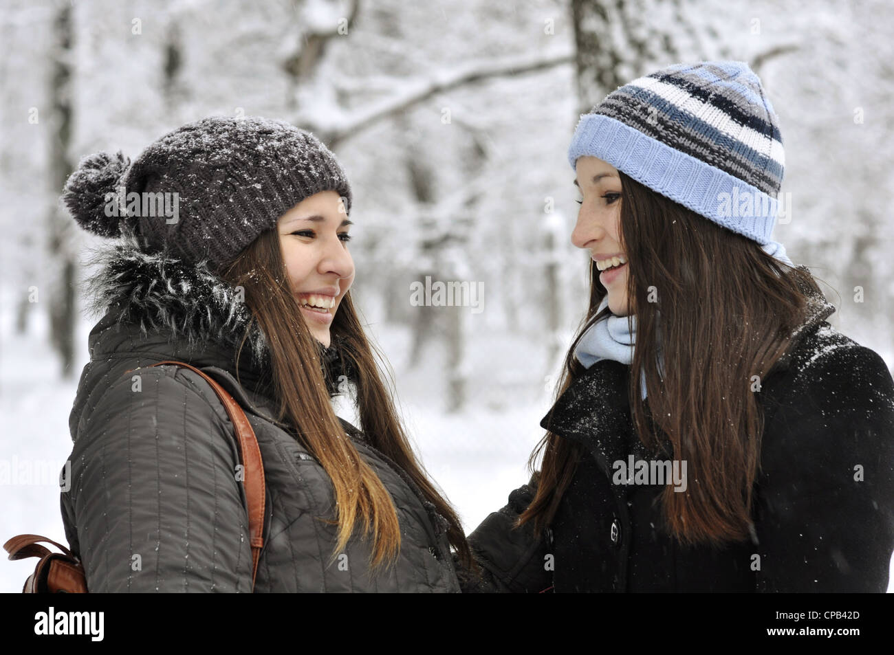 Two beautiful young girls in winter park Stock Photo - Alamy