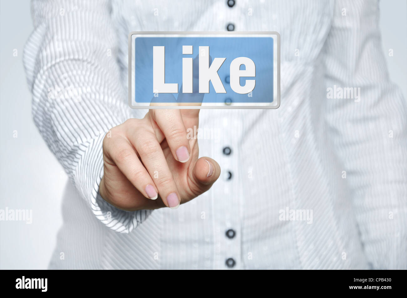 Woman pressing social network button with one hand Stock Photo