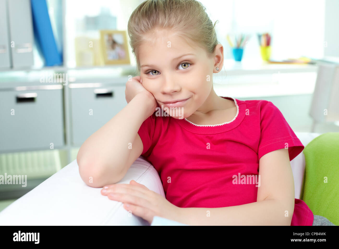 Portrait of lovely girl sitting on sofa at home Stock Photo - Alamy