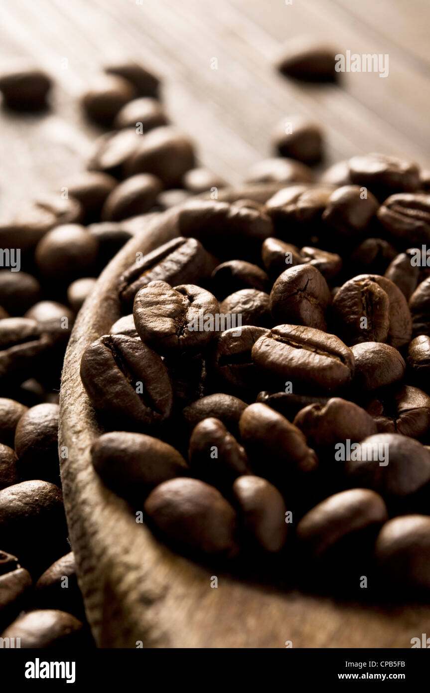 roasted coffee beans and wood spoon Stock Photo Alamy
